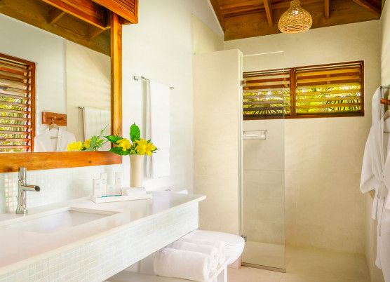 a suite bathroom with white marble and a walk in shower