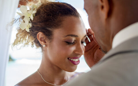 groom lightly grazes the side of the brides face