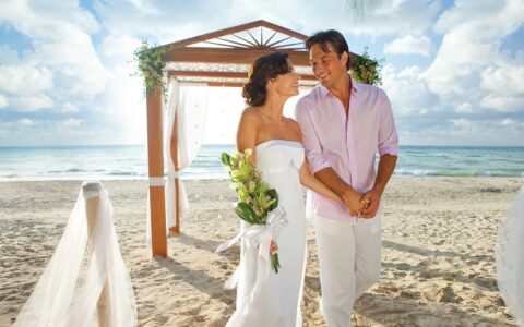 bride and groom in casual clothing at their beach wedding ceremony