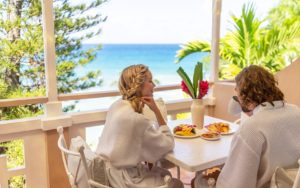 A couples enjoying breakfast overlooking the sea in Couples Resorts Jamaica